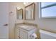 Bathroom featuring a granite countertop vanity, mirror, and toilet at 14522 W Windcrest Dr, Sun City West, AZ 85375