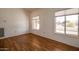 Bright Living Room featuring hardwood floors, natural light, and a view of the neighborhood at 14522 W Windcrest Dr, Sun City West, AZ 85375