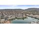 Aerial view of a community overlooking a lake and surrounding mountain ranges, and mature landscaping at 16013 S Desert Foothills Pkwy # 2120, Phoenix, AZ 85048