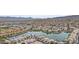 Aerial view showcases a community overlooking a lake with mature landscaping and views of the mountains at 16013 S Desert Foothills Pkwy # 2120, Phoenix, AZ 85048