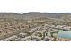 Scenic aerial view of a residential neighborhood with a lake and mountain backdrop at 16013 S Desert Foothills Pkwy # 2120, Phoenix, AZ 85048
