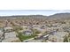 Aerial view of a well-maintained community with mature landscaping, a pool, and mountain views at 16013 S Desert Foothills Pkwy # 2120, Phoenix, AZ 85048