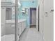 Bright bathroom with white cabinets, a framed mirror, updated flooring, and walk-in shower with glass door at 16013 S Desert Foothills Pkwy # 2120, Phoenix, AZ 85048