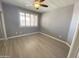 A cozy bedroom featuring carpet, ceiling fan, and large windows with plantation shutters at 16013 S Desert Foothills Pkwy # 2120, Phoenix, AZ 85048