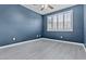 Bedroom with hardwood floors featuring modern paint color, ceiling fan, and a window with shutters at 16013 S Desert Foothills Pkwy # 2120, Phoenix, AZ 85048