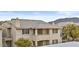 Multi-story condo showcases its tile roof and balconies, set against a backdrop of desert terrain at 16013 S Desert Foothills Pkwy # 2120, Phoenix, AZ 85048
