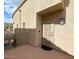 Exterior view of a secure front door entrance, accented by small windows and a balcony at 16013 S Desert Foothills Pkwy # 2120, Phoenix, AZ 85048