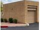 Tan stucco garage with a two-car garage door and manicured landscaping with gravel at 16013 S Desert Foothills Pkwy # 2120, Phoenix, AZ 85048
