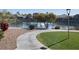 Picturesque view of the lakefront, showcasing lush landscaping, a peaceful walking path, and community amenities at 16013 S Desert Foothills Pkwy # 2120, Phoenix, AZ 85048