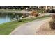 Peaceful lakeside view featuring a walking path, bench, and native landscaping, creating a serene atmosphere at 16013 S Desert Foothills Pkwy # 2120, Phoenix, AZ 85048