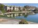 Waterfront condos reflect in a tranquil lake framed by green landscaping creating an idyllic community setting at 16013 S Desert Foothills Pkwy # 2120, Phoenix, AZ 85048