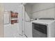 A laundry room featuring new white appliances and access to the kitchen at 16013 S Desert Foothills Pkwy # 2120, Phoenix, AZ 85048