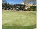 Lush putting green with a shaded pergola area; perfect for a relaxing day outdoors at 16013 S Desert Foothills Pkwy # 2120, Phoenix, AZ 85048