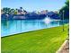 Scenic waterfront view with lush green grass, complemented by beautiful homes and a tranquil fountain at 16013 S Desert Foothills Pkwy # 2120, Phoenix, AZ 85048