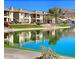 Scenic waterfront view of townhomes with balconies reflecting in the lake on a clear day at 16013 S Desert Foothills Pkwy # 2120, Phoenix, AZ 85048