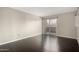 A bright bedroom with hardwood floors and sliding glass doors leading to the balcony at 1645 W Baseline Rd # 2122, Mesa, AZ 85202