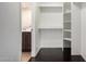 Walk-in closet with built-in shelves offering ample storage, conveniently located next to the bathroom at 1645 W Baseline Rd # 2122, Mesa, AZ 85202
