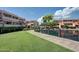 Exterior view of the complex's pond and gazebo surrounded by green grass and well-maintained residential buildings at 1645 W Baseline Rd # 2122, Mesa, AZ 85202