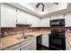 Well-lit kitchen featuring stainless steel sink, black appliances, and ample cabinetry at 1645 W Baseline Rd # 2122, Mesa, AZ 85202