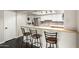 Bright kitchen with bar seating, stainless appliances, and modern cabinetry at 1645 W Baseline Rd # 2122, Mesa, AZ 85202