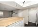 Bright kitchen features a breakfast bar, neutral cabinets, and convenient access to the laundry area at 1645 W Baseline Rd # 2122, Mesa, AZ 85202