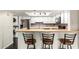 Eat-in kitchen with bar seating, stainless steel appliances, and laundry area at 1645 W Baseline Rd # 2122, Mesa, AZ 85202
