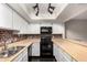 Bright eat-in kitchen with track lighting, updated cabinets and modern appliances at 1645 W Baseline Rd # 2122, Mesa, AZ 85202