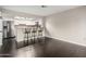 Bright kitchen boasts stainless fridge, bar seating, and modern white cabinets at 1645 W Baseline Rd # 2122, Mesa, AZ 85202