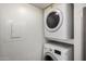 This functional laundry area features a stacked washer and dryer for convenient in-home laundry at 1645 W Baseline Rd # 2122, Mesa, AZ 85202
