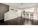 Spacious living room leading to a kitchen with bar seating and laundry at 1645 W Baseline Rd # 2122, Mesa, AZ 85202