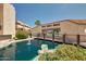 Complex's attractive pond features a bridge and water feature, surrounded by rocks, greenery, and residential buildings at 1645 W Baseline Rd # 2122, Mesa, AZ 85202