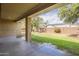 Covered patio overlooking the lawn, mature trees, and a block wall creating a private outdoor oasis at 18624 E Cattle Dr, Queen Creek, AZ 85142