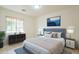Cozy bedroom with a comfortable bed, neutral decor, and a large window at 18624 E Cattle Dr, Queen Creek, AZ 85142