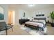 Modern bedroom with dark wood furniture, neutral walls, and comfortable seating at 18624 E Cattle Dr, Queen Creek, AZ 85142