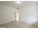 A clean and bright bedroom features wood-look floors, a ceiling light, and double-door closet at 18624 E Cattle Dr, Queen Creek, AZ 85142