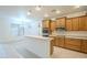 Bright kitchen featuring wooden cabinets, a breakfast bar, and modern stainless steel appliances at 18624 E Cattle Dr, Queen Creek, AZ 85142