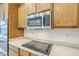 Kitchen features stainless steel microwave, oven, and smooth top electric cooktop at 18624 E Cattle Dr, Queen Creek, AZ 85142