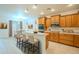 Bright kitchen featuring wooden cabinets, stainless steel appliances, and a breakfast bar with seating at 18624 E Cattle Dr, Queen Creek, AZ 85142