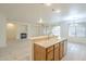 Open kitchen with island and double sink with view of living room and fireplace at 18624 E Cattle Dr, Queen Creek, AZ 85142