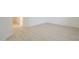 Empty living room with light colored wood flooring at 18624 E Cattle Dr, Queen Creek, AZ 85142