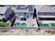 Aerial view of backyard features a kidney-shaped pool, patio, and solar panels atop a two-story home at 19061 N Toya St, Maricopa, AZ 85138