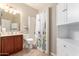 Cozy bathroom with a shower, vanity, and white cabinets at 19061 N Toya St, Maricopa, AZ 85138