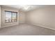 Spacious bedroom with neutral tones, plush carpet, and bright natural light from a window at 19061 N Toya St, Maricopa, AZ 85138