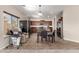 Bright kitchen and dining area combination featuring tile floors and stainless steel appliances at 19061 N Toya St, Maricopa, AZ 85138