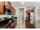 Beautiful kitchen featuring dark cabinetry and stainless steel appliances at 19061 N Toya St, Maricopa, AZ 85138