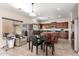 Open kitchen with stainless steel appliances, island, and dark wood cabinetry at 19061 N Toya St, Maricopa, AZ 85138