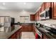 Kitchen boasts stainless steel appliances and granite countertops at 19061 N Toya St, Maricopa, AZ 85138