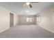Bright living room with large windows and neutral carpet at 19061 N Toya St, Maricopa, AZ 85138