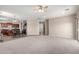 Open living area flows into a modern kitchen with dark cabinets and stainless steel appliances at 19061 N Toya St, Maricopa, AZ 85138