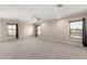 Expansive living room with natural light and neutral carpet at 19061 N Toya St, Maricopa, AZ 85138